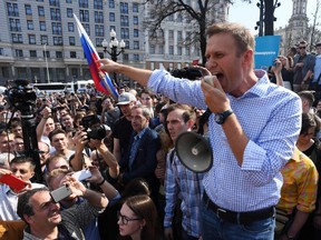 In this file photo taken on May 05, 2018 Russian opposition leader Alexei Navalny addresses supporters during an unauthorized anti-Putin rally in Moscow, two days ahead of Vladimir Putin's inauguration for a fourth Kremlin term.