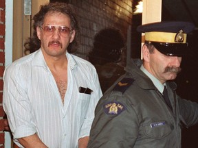 Allan Legere departs from court in Burton, New Brunswick, as he waits for jurors in his murder trial to return a verdict in Burton, N.B. on Nov. 2, 1991.