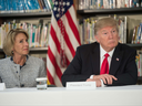 US President Donald Trump and Education Secretary Betsy DeVos listen during a meeting with parents and teachers at Saint Andrew Catholic School in Orlando, Florida, on March 3, 2017. 
