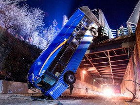 A New York City double-length bus crashed through a barrier on an overpass late Thursday.