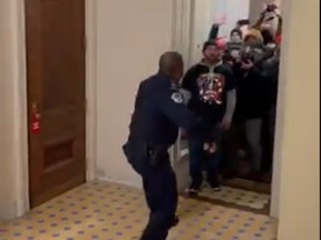 Capitol police officer Eugene Goodman is pictured fending off rioters as they entered the Capitol building.