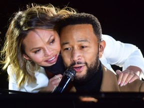 Singer John Legend is joined onstage by his wife, Chrissy Teigen, while performing before Kamala Harris at a drive-in rally on November 2, 2020 in Philadelphia.