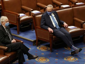 Senate Majority Leader Mitch McConnell (L) and Senate Democratic Leader Chuck Schumer are seen during a joint session of Congress after they reconvened to certify the Electoral College votes of the 2020 presidential election in the House chamber in Washington, U.S. January 6, 2021.