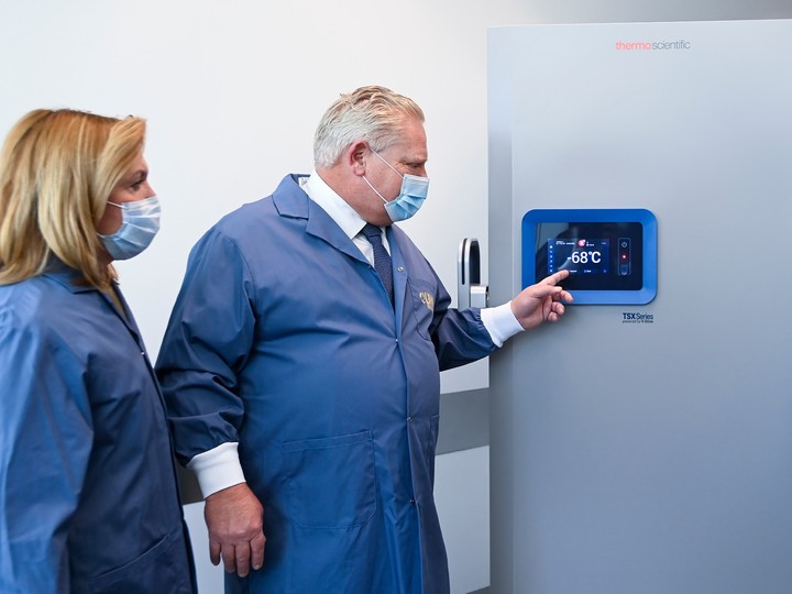  Ontario Premier Doug Ford, right, and Ontario Health Minister Christine Elliott look at freezers ahead of COVID-19 vaccine distribution in Toronto, Tuesday, Dec. 8, 2020.
