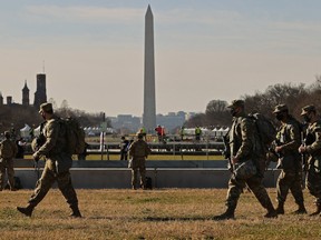 National Guard troops move along the National Mall the day after the House of Representatives voted to impeach President Donald Trump for the second time January 14, 2021 in Washington, DC.