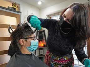 Anna Posteraro gets her hair styled by Alysha Goertzen at "Alyshageehair" on Tuesday January 19, 2021. The government of Alberta allowed hair salons to re-open for business in the province  this week after a lockdown during the COVID-19 pandemic.