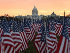 The U.S Capitol Building is prepared for the inaugural ceremonies for President-elect Joe Biden as American flags are placed in the ground on the National Mall on Janu. 18, 2021 in Washington, D.C.