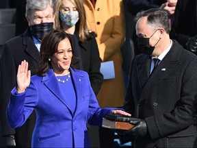 Kamala Harris, flanked by her husband Doug Emhoff, is sworn in as the 49th US Vice President by Supreme Court Justice Sonia Sotomayor on January 20, 2021, at the US Capitol in Washington, DC.