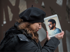 Maral Gorginpour stands out front of her Toronto home with a portrait of her husband who was killed when Ukraine Airlines Flight PS752 was shot down by the Iranian military days after they were married, Wednesday January 6, 2021.