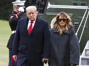 U.S. President Donald Trump and First Lady Melania Trump depart Marine One on the South Lawn of the White House on Dec. 31, 2020 in Washington, DC.