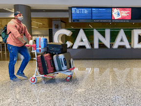 A traveller walks through the Calgary Airport on Wednesday, December 30, 2020.