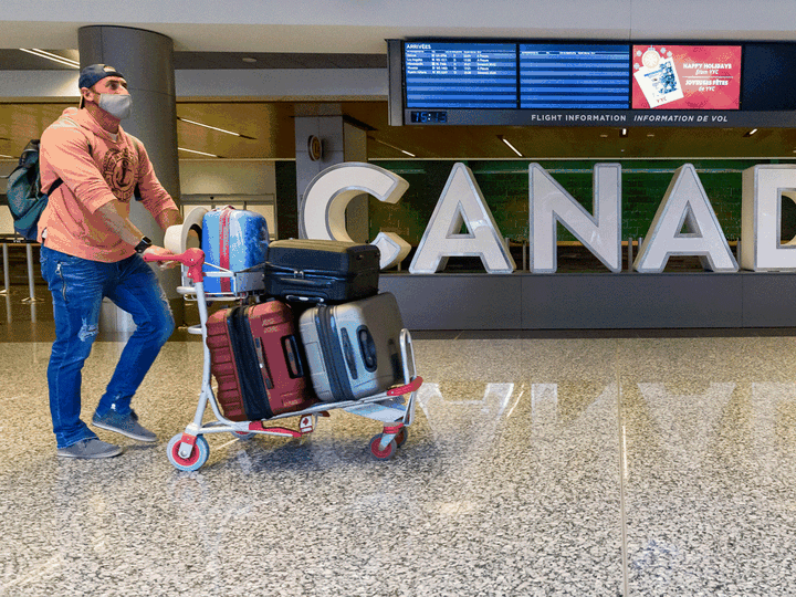  A traveller walks through the Calgary Airport on Wednesday, December 30, 2020.