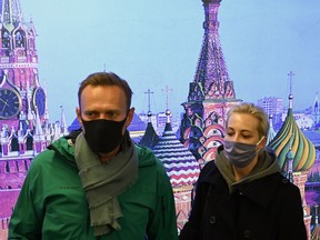 Russian opposition leader Alexei Navalny and his wife, Yulia, Moscow's Sheremetyevo airport upon the arrival from Berlin on Jan. 17, 2021.
