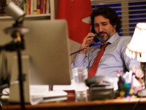 Canada's Prime Minister Justin Trudeau speaks on the phone with U.S. President Joe Biden, who made the first call to a foreign leader following his inauguration, in Ottawa, Ontario, Canada January 22, 2021.