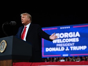 In this file photo taken on December 05, 2020 US president Donald Trump speaks at a rally to support Republican Senate candidates at Valdosta Regional Airport in Valdosta, Georgia.