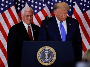 U.S. President Donald Trump and Vice President Mike Pence stand while making remarks about early results from the 2020 U.S. presidential election in the East Room of the White House in Washington, U.S., November 4, 2020.