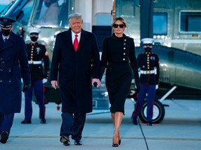 Outgoing U.S. President Donald Trump and First Lady Melania Trump step out of Marine One at Joint Base Andrews in Maryland on January 20, 2021.