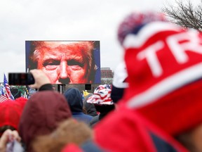 U.S. President Donald Trump is seen on a screen speaking to supporters during a rally to contest the certification of the 2020 U.S. presidential election results by the U.S. Congress, in Washington, U.S, January 6, 2021. Picture taken January 6, 2021.