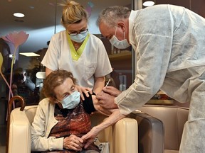 Denise Wayaffe, 91-yearS-old, is vaccinated by Doctor Alberto Parada during the vaccination of residents of the La Bouviere elderly home in Vielsalm on January 7, 2021, marking the start of the vaccination campaign with the Pfizer-vaccine in the Luxembourg province.