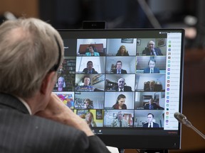 Canadian Members of Parliament are shown on a monitor during a virtual session of the House of Commons on April 28, 2020 in Ottawa.