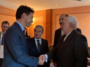 Prime Minister Justin Trudeau, left, shakes hands with Iranian Foreign Minister Javad Zarif on Feb. 14, 2020.
