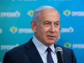 Israeli Prime Minister Benjamin Netanyahu attends a ceremony marking the four millionth person to be vaccinated at the Leumit Health Care Services vaccination facility in Jerusalem on Feb. 16.