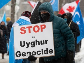 Protesters gather outside the Parliament buildings in Ottawa on Feb. 22, as the House prepared to vote on an Opposition motion calling on Canada to recognize China's actions against ethnic Muslim Uighurs as genocide.