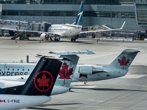 Air Canada and WestJet planes sit on the tarmac at Pearson International Airport in Toronto on June 18, 2020.