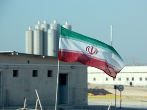 An Iranian flag flutters in front of Iran's Bushehr nuclear power plant.