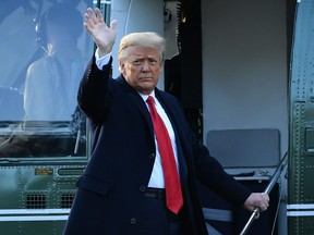 Outgoing US President Donald Trump waves as he boards Marine One at the White House in Washington, DC, on January 20, 2021.