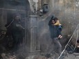 Civilians carry young victims at the scene of an explosion in the Syrian town of Azaz, in the rebel-controlled northern countryside of Aleppo province, on Jan. 31.