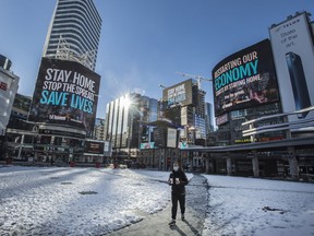 A pedestrian walks through Dundas Square in Toronto on Feb. 3.