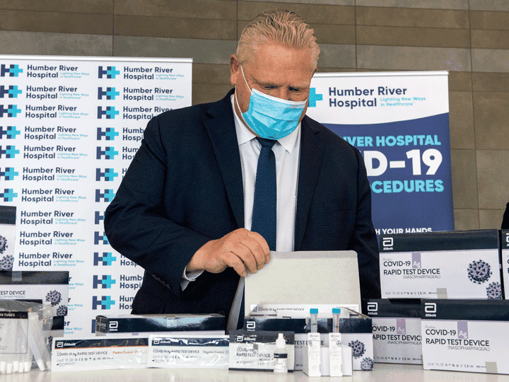  Ontario Premier Doug Ford examines COVID-19 Rapid Test Device kits at Humber River Hospital in Toronto, November 24, 2020.