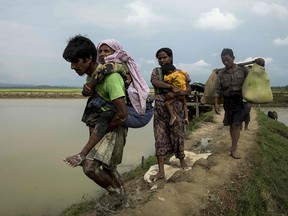 Rohingya refugees from Rakhine state in Myanmar walk near Ukhia, at the border between Bangladesh and Myanmar, as they flee violence, in a file photo from 2017.