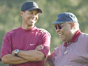 Tiger Woods and his father, Earl, smile after he won the Target World Challenge on December 12, 2004 at Sherwood Country Club in Thousand Oaks, California.