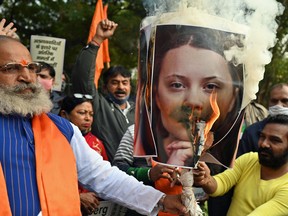 United Hindu Front activists burn a picture of Swedish climate activist Greta Thunberg in New Delhi on February 4, 2021.