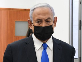 Israeli Prime Minister Benjamin Netanyahu looks on as he arrives to a hearing in his corruption trial at Jerusalem's District Court February 8, 2021.
