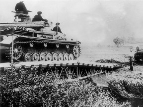 Germans tanks cross a river into Polish territory as Nazi forces invade Poland from the west on September 1, 1939.