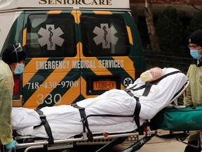Emergency Medical Technicians wheel a man out of a nursing home in the Brooklyn borough of New York on April 17, 2020. The state recently adjusted the number of long-term care residents it says have died of COVID from 8,500 to 15,000.