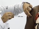 A health worker receives a COVID-19 vaccine in Rio de Janeiro, Brazil.