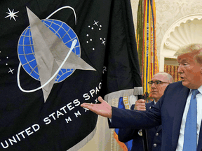 Then-U.S. President Donald Trump gestures towards the U.S. Space Force flag during a presentation in the Oval Office, May 15, 2020.