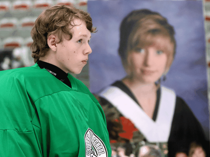  Tanner Fitzpatrick skates past a photo of Marit McKenzie during the Marit Cup charity tournament in Calgary on August 26, 2014. Fitzpatrick received McKenzie’s heart in a transplant when she died in 2013.