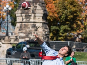 Prime Minister Justin Trudeau throws a pass as the Saskatchewan Roughriders practise on Parliament Hill in a file photo from Oct. 11, 2016.