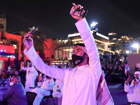 People cheer as they watch screens displaying information of the Hope Probe entering the orbit of Mars, in Dubai, United Arab Emirates, February 9, 2021.