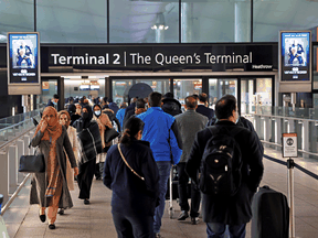 People queue to enter Terminal 2 at Heathrow Airport as tighter rules for international travellers start amid the COVID-19 pandemic, London, Britain, January 18, 2021.