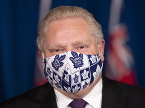 Ontario Premier Doug Ford wears his Toronto Maple Leafs mask during the daily briefing in Toronto on Monday, Feb. 8, 2021.