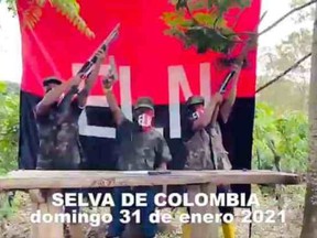 Three masked and armed men wielding guns and standing in front of an ELN flag are pictured declaring their support for Andres Arauz.
