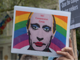 Banner with Putin wearing makeup appeared on a protest against the LGBTQ prosecution in Chechnya near the Russian embassy in 2017.