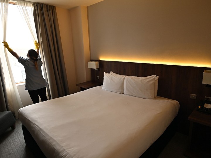  A member of the cleaning staff prepares a room for a guest at the St Giles Hotel, near Heathrow Airport in west London, on February 10, 2021.