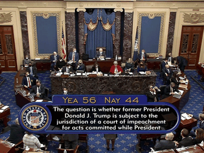 U.S. senators vote on whether former President Donald Trump is able to be impeached after having left office, on the floor of the Senate chamber on Capitol Hill, February 9, 2021.